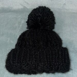 BP Black Knit Hat with Pom Pom on top.